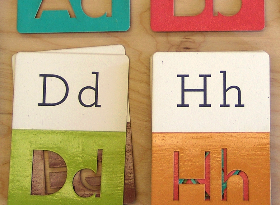 Cards with D and H letters displayed capital and lowercase. The bottom half of both cards features cut out, traceable letters.